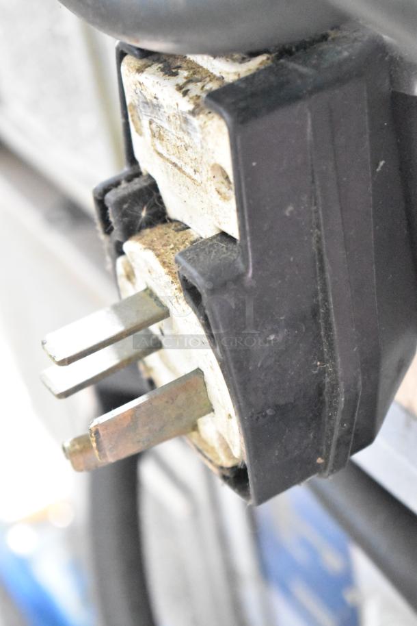 Close-up of a plug connected to a Turbochef HhC2020 commercial oven, showing wear and discoloration.