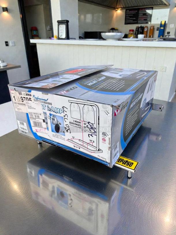 Brand new Winco EHL-2 dual heat lamp in original box, UL & NSF listed, features adjustable height.