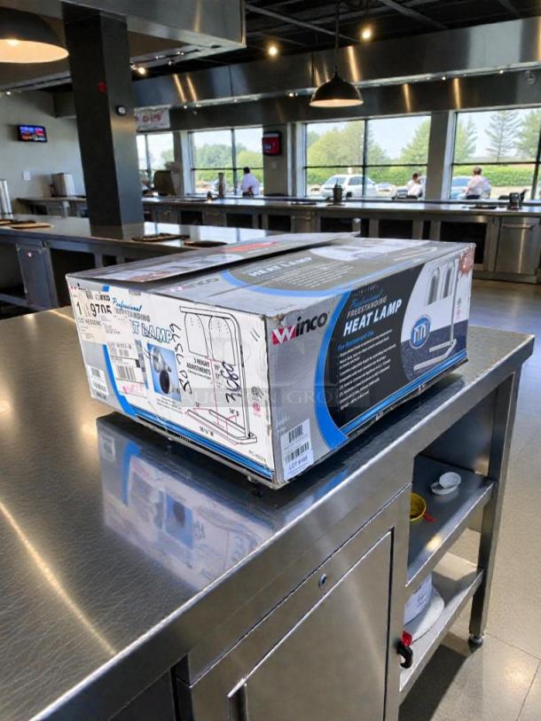 Brand new Winco EHL-2 dual heat lamp in original box, UL & NSF listed, professional freestanding design for commercial use.