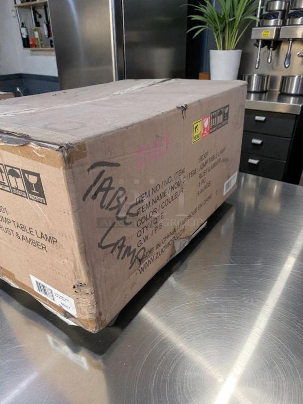 Brand new box for Zuomor Jump Table Lamp Set, 3-light rustic amber glass, model ZUO-S-LMP-0297, unopened condition.