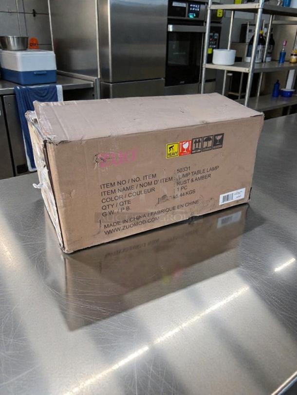 Boxed Zuomor Jump Table Lamp Set, new condition. Includes 3-light rustic amber glass lamps. Original packaging with item details.