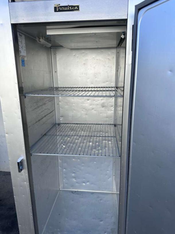 Alt text: Traulsen G12010 commercial reach-in freezer, single door, outstanding condition, three shelves, 115V, UL & NSF listed.