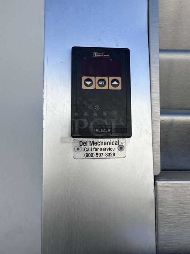 Traulsen G12010 commercial reach-in freezer control panel. Silver finish, call-for-service label visible.