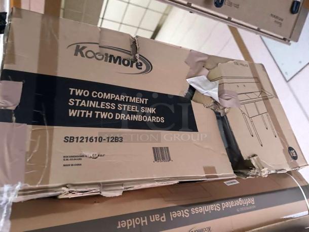 Brand new KoolMore SB121610-12B3 stainless steel two-compartment sink with dual drainboards in original box, NSF certified.