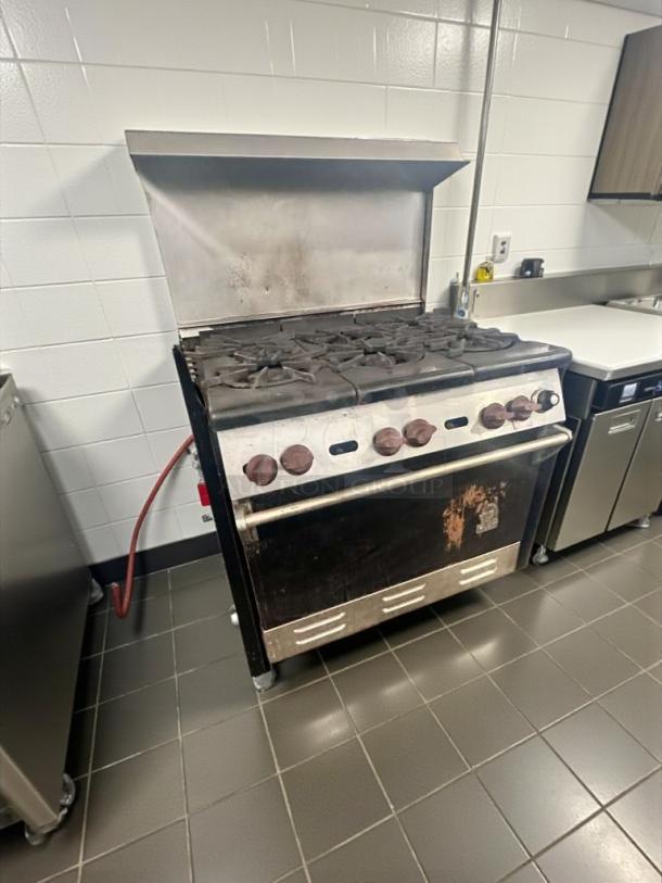 Commercial gas range with oven, 6 burners, NSF certified, fully tested, operational, model GAS-L-RNG-0321, excellent condition.