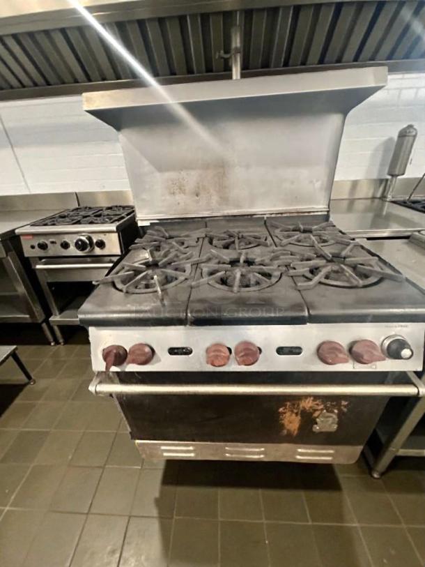 Commercial 6-burner gas range with oven, NSF certified, fully operational, USA make, model GAS-L-RNG-0321, used condition.