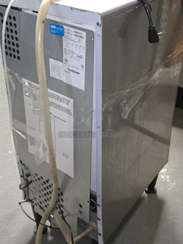 Scotsman CU0715MA-1 ice machine, high-grade condition, self-contained, air-cooled, UL listed, tags detailing specs.