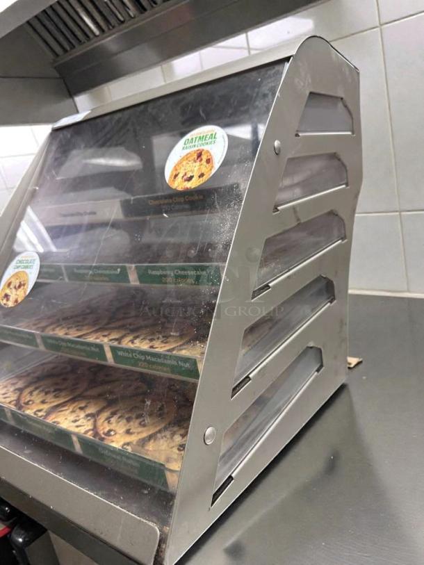 Commercial countertop bakery display case, multi-tier, in exceptional condition. Includes visible cookie labels and operational features.