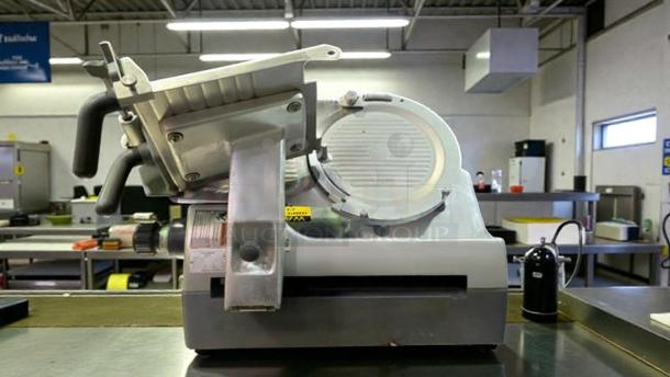 Hobart 2912 commercial automatic meat slicer, refined condition, 120V single phase, fully tested, side view in industrial setting.