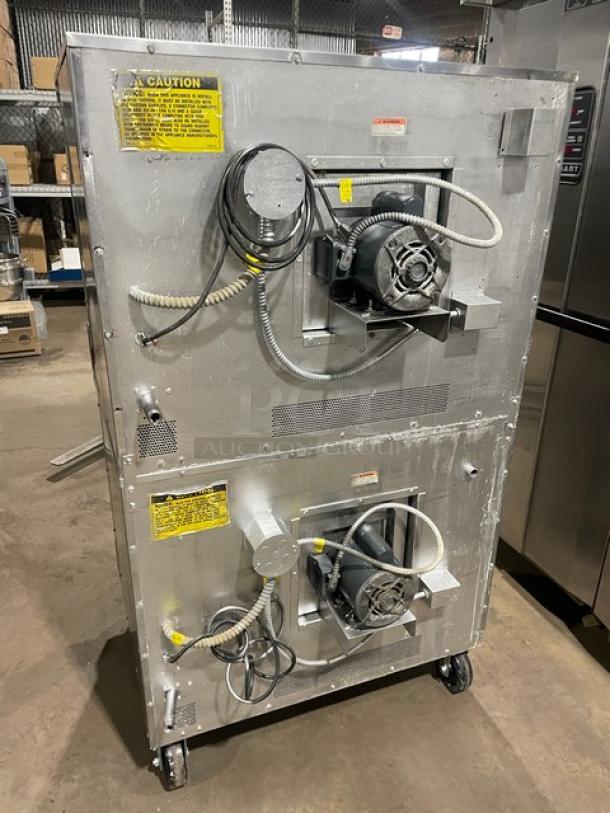 Vulcan VC4GD-SEFCCC stainless steel double-stacked gas convection oven on casters, rear view with wiring and caution labels.