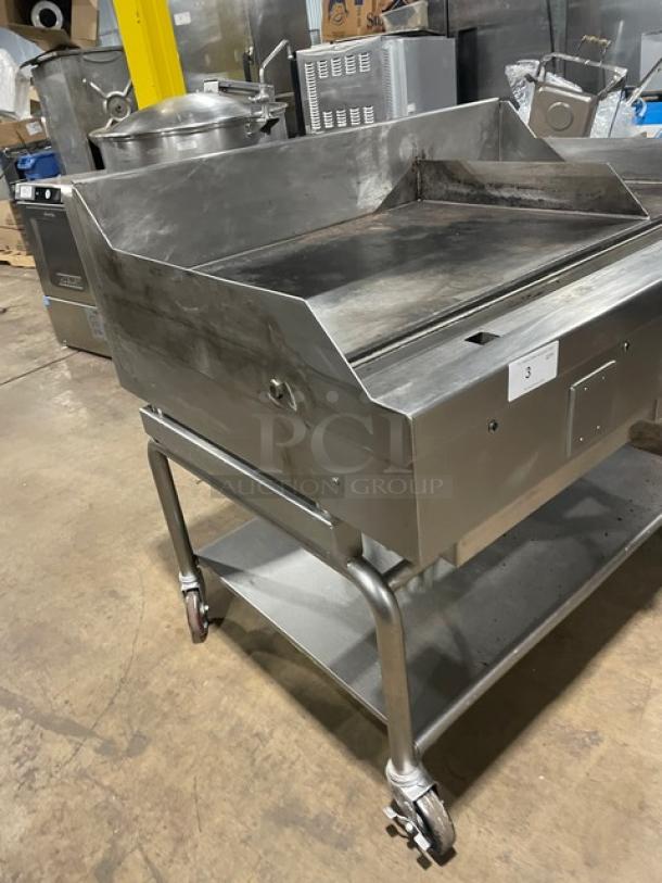 WoodStone stainless steel natural gas griddle, model WSPL48364CT00NG, with back/side splash, undershelf, and casters.