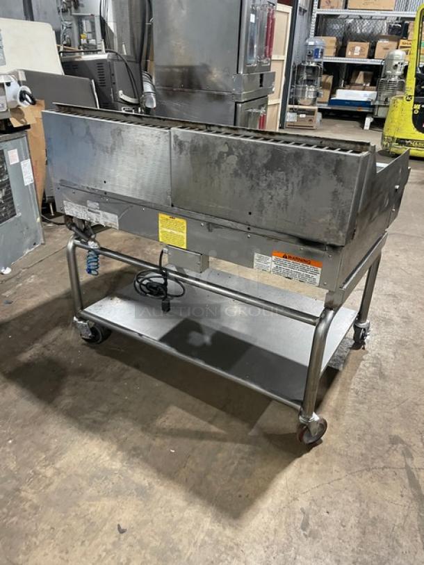 WoodStone stainless steel natural gas countertop split top plancha griddle with back and side splash, undershelf cart, model WSPL48364CT00NG, on casters.