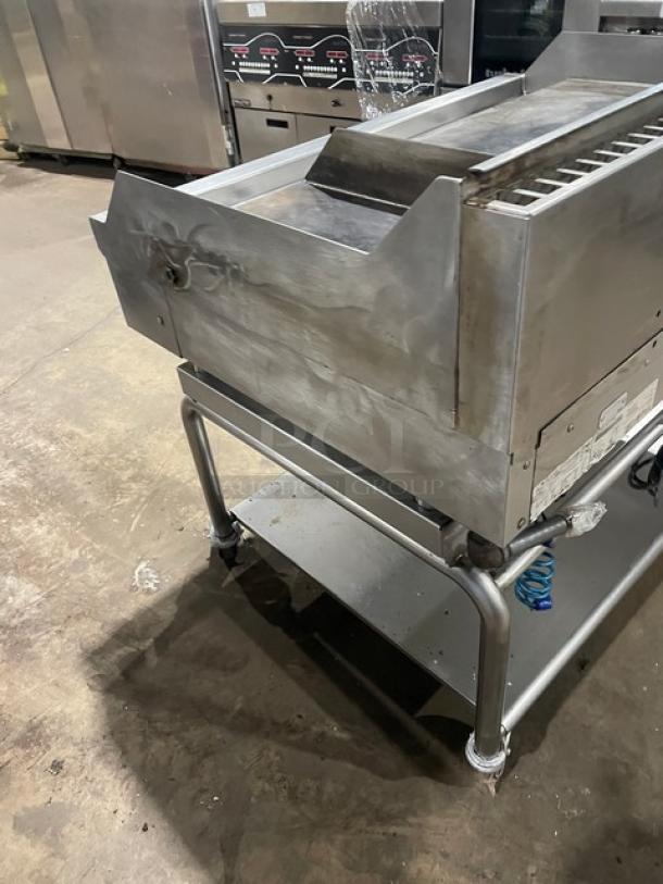WoodStone stainless steel natural gas flat griddle, model WSPL48364CT00NG, on casters with splash guards and undershelf.