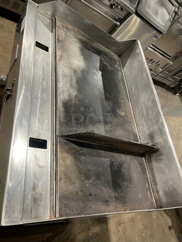 WoodStone stainless steel countertop split top plancha griddle, model WSPL48364CT00NG, with back/side splash, on casters.