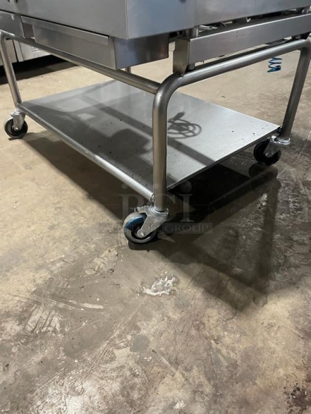 WoodStone stainless steel plancha griddle on casters with undershelf, model WSPL48364CT00NG, featuring back and side splash.