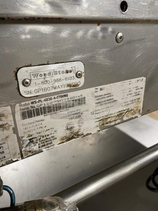 WoodStone stainless steel countertop split top plancha flat griddle, model WS-PL-4836-4-CT00NG, with labels, on casters.