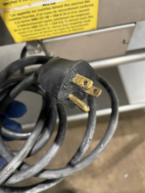 Close-up of a power plug for the WoodStone Commercial Griddle, showing a 120V 1 Phase connection.