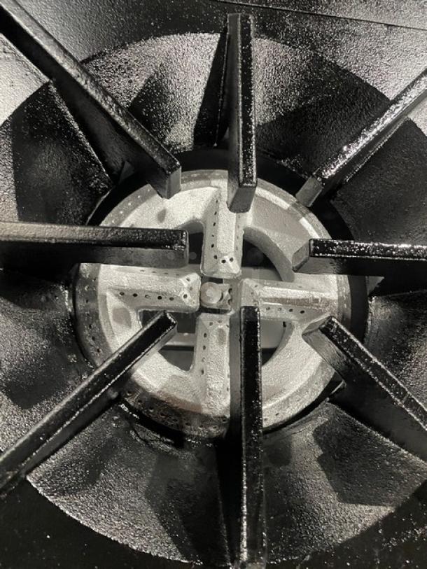 Tri-Star Commercial Stainless Steel Gas Burner. Features durable cast iron grates. Part of a 6-burner range/oven combo.