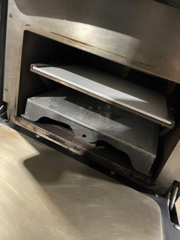 TurboChef Model NGO ventless rapid cook oven interior, featuring a cooking chamber with a ceramic plate, stainless steel surface, and visible crank bar.