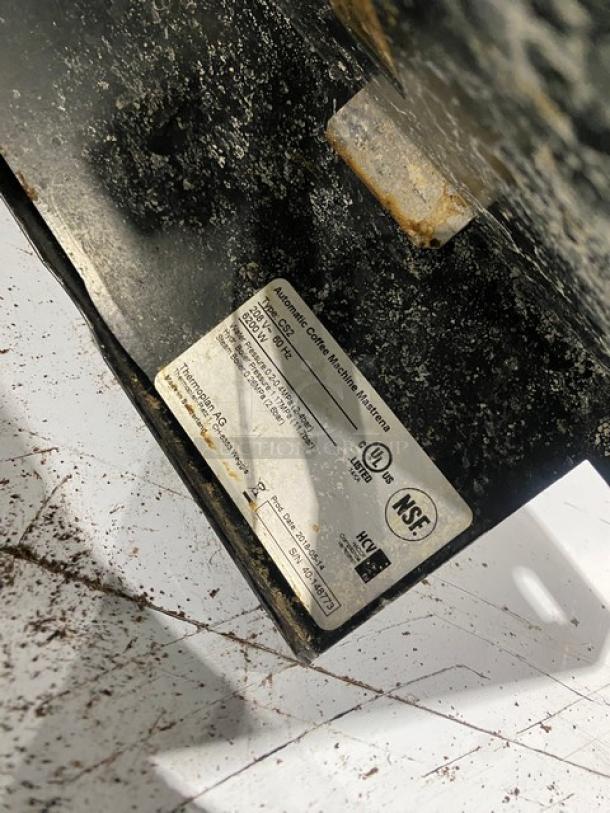 Alt text: Mastrena CS2 espresso machine control panel close-up, showing model and certification labels, used condition.