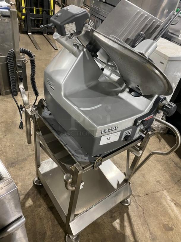 Hobart model 2912 countertop meat slicer in excellent condition on a new stainless steel deli cart with casters.