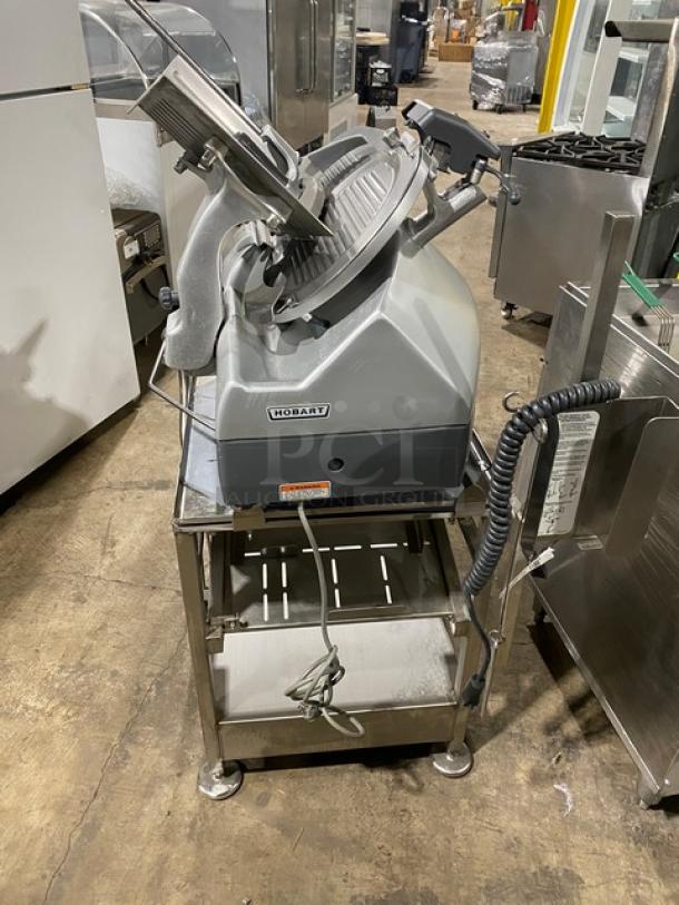 Hobart Model 2912 commercial deli meat slicer on new undershelf cart. Features electric power, 120V, and single-phase, with casters.