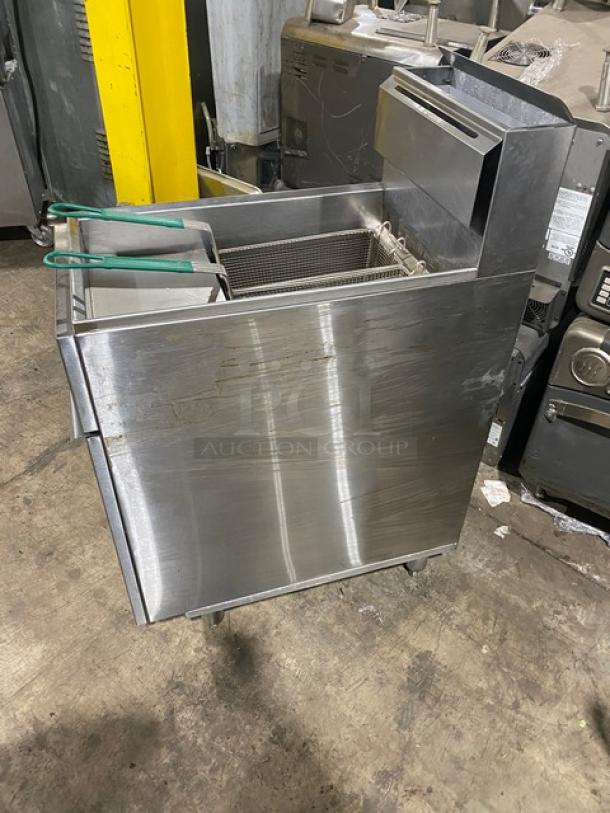 American Range commercial stainless steel gas fryer with backsplash, basket hanger, and fry basket. On sturdy legs.