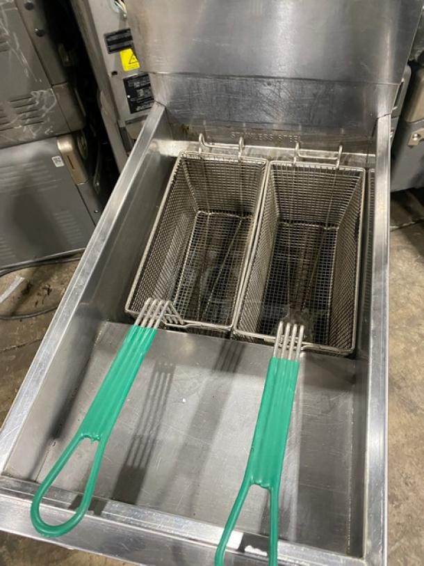 American Range commercial stainless steel gas fryer with backsplash, basket hanger, two fry baskets, and legs.