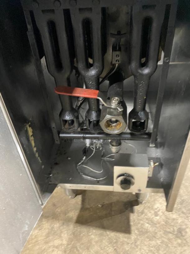 American Range stainless steel gas fryer, with back splash, basket hanger, and fry basket; on legs, used condition.