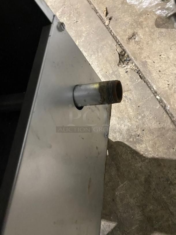 American Range stainless steel gas fryer detail, showing a side pipe fitting. Includes backsplash and basket hanger.