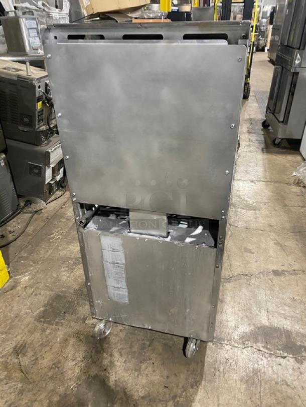 American Range stainless steel 4-burner gas range/oven combo with backsplash, salamander shelf, and wired oven rack on casters.