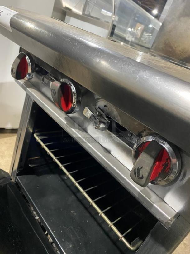 American Range stainless steel gas 4-burner range/oven combo with wired oven rack, backsplash, and salamander shelf. On casters.