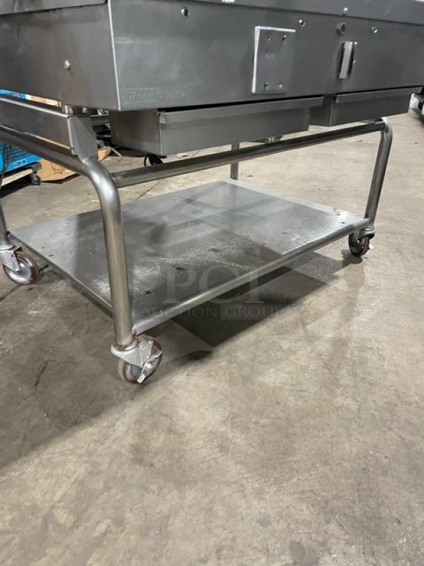 WoodStone stainless steel gas-powered 48" plancha griddle with back and side splash, on caster cart with undershelf, SN: GP1B16MAY1704992.