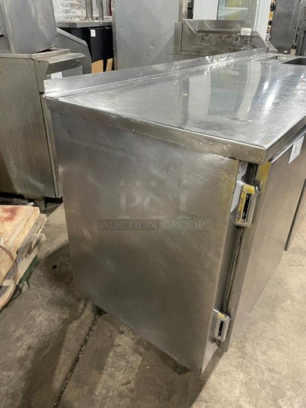Commercial stainless steel 2-door refrigerated worktop station with single compartment sink. Mounted on legs. Durable condition.
