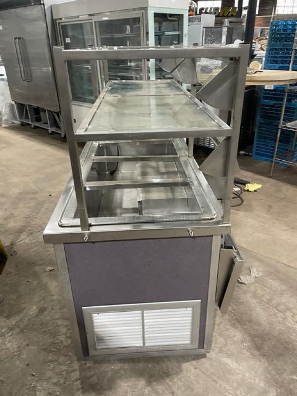 Atlas Metal 60" refrigerated cold food bar with sneeze guard, model WCM-BT-4. Features 4 wells, tray slide, and storage.