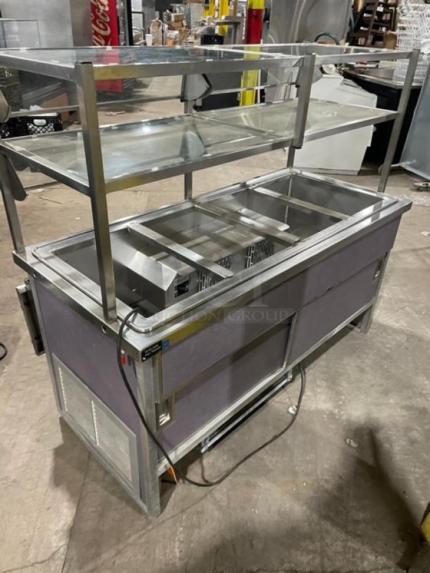 Atlas Metal stainless steel 60" refrigerated salad bar with sneeze guard and tray slide. Features four cold wells and enclosed storage. Model WCMBT4, 115V, on casters.