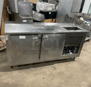 Commercial stainless steel 2-door refrigerated worktop station with single compartment sink, on legs, used condition.