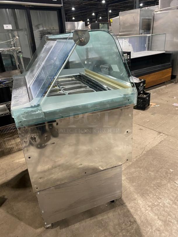 Gencarelli's Style 10-pan gelato case in stainless steel with sliding doors, on casters, shows minor wear, ideal for commercial use.