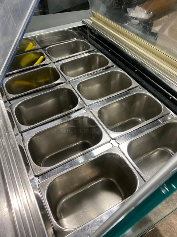 Commercial stainless steel 10-pan gelato case with sliding door access, on casters. Features include durable build and ample space for ice cream presentation.