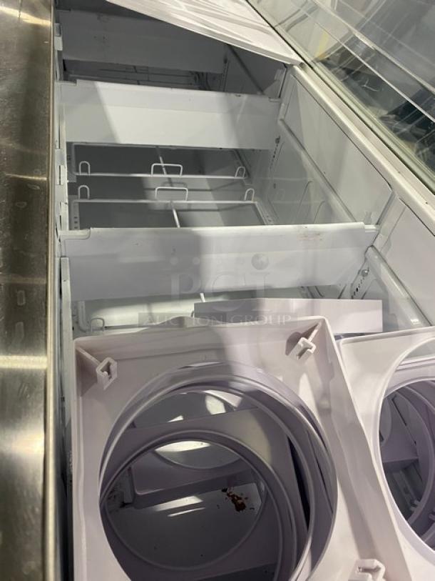 Global Baskin Robin's-style white ice cream dipping cabinet with dual lift-open doors and tub holders visible.