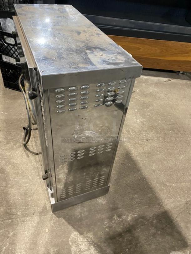 Robot Coupe commercial stainless steel rotisserie cabinet with legs, showing signs of wear, for countertop use.