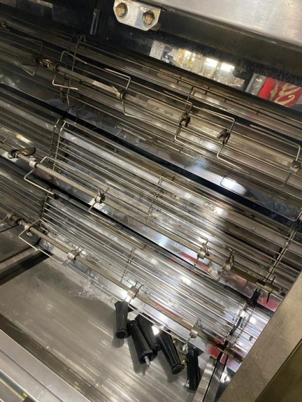 Robot Coupe commercial countertop rotisserie cabinet with stainless steel interior and multiple spits. Includes legs. Used condition.