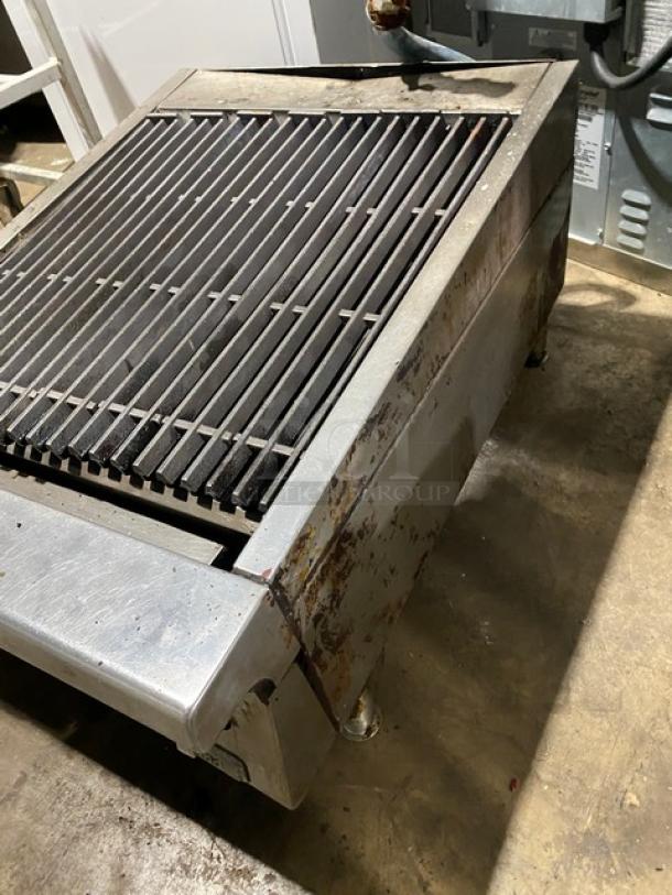 Garland 24" commercial stainless steel gas char broiler with cast iron grates. Countertop model on legs. Used condition.