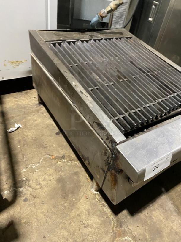 Garland 24" commercial stainless steel gas char broiler with cast iron grates, on legs, used condition.