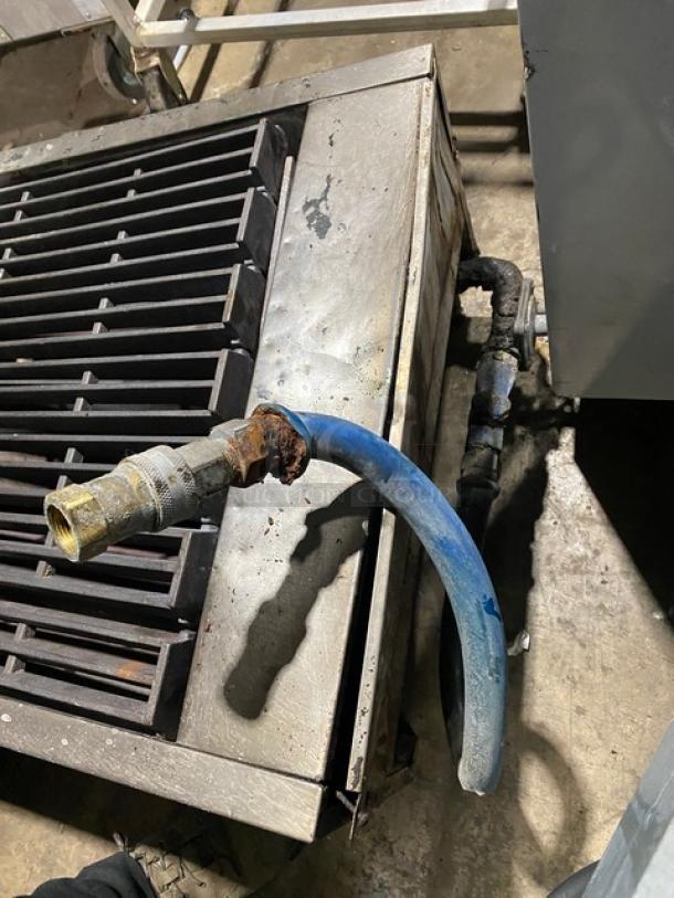 Garland commercial 24" gas char broiler with stainless steel body, cast iron grates. Features gas hook-up and legs. Used condition.