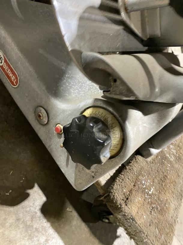 Berkel commercial electric deli slicer, heavy-duty countertop model. Features adjustable thickness knob, visible wear.