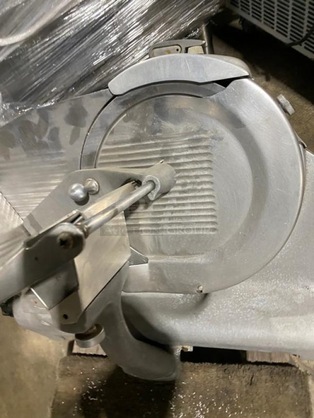 Berkel commercial electric countertop meat slicer, heavy-duty, silver metal finish, used condition, suitable for deli use.