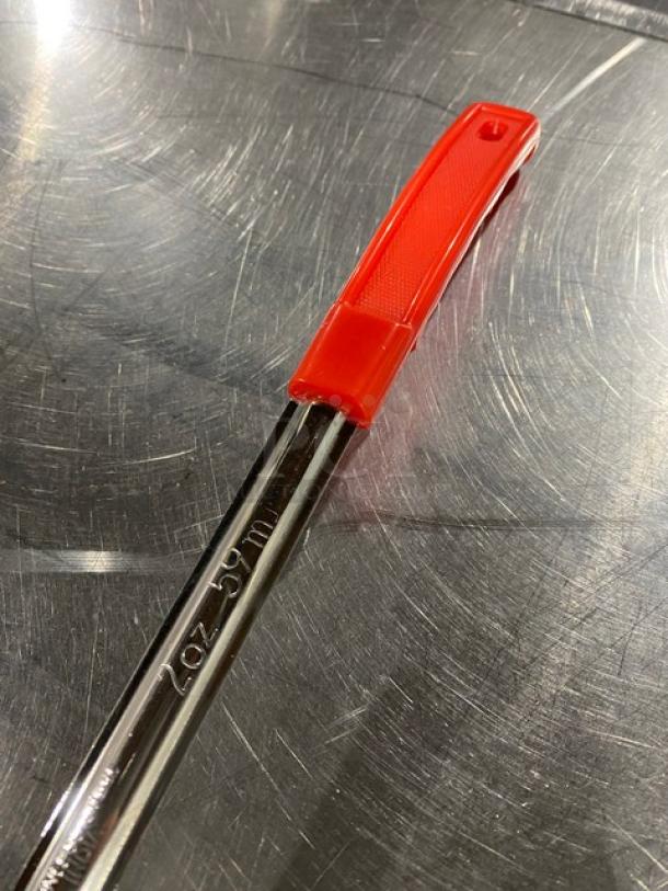 Crestware SP02 2 oz. stainless steel portion control spoon with red grip handle, new condition, marked "2 oz - 59 ml".