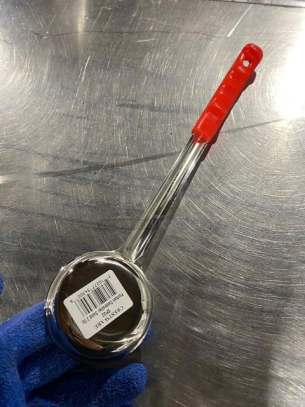 Crestware SP02 stainless steel 2 oz. portion control spoon with red grip handle, new condition. Barcoded tag visible.