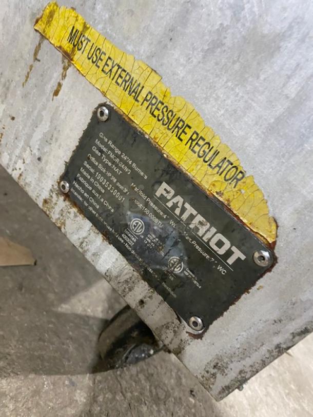Patriot commercial stainless steel range/oven, Model FMGR24NG, SN: 19035330001, natural gas, 4 burners, label shows pressure regulator notice.